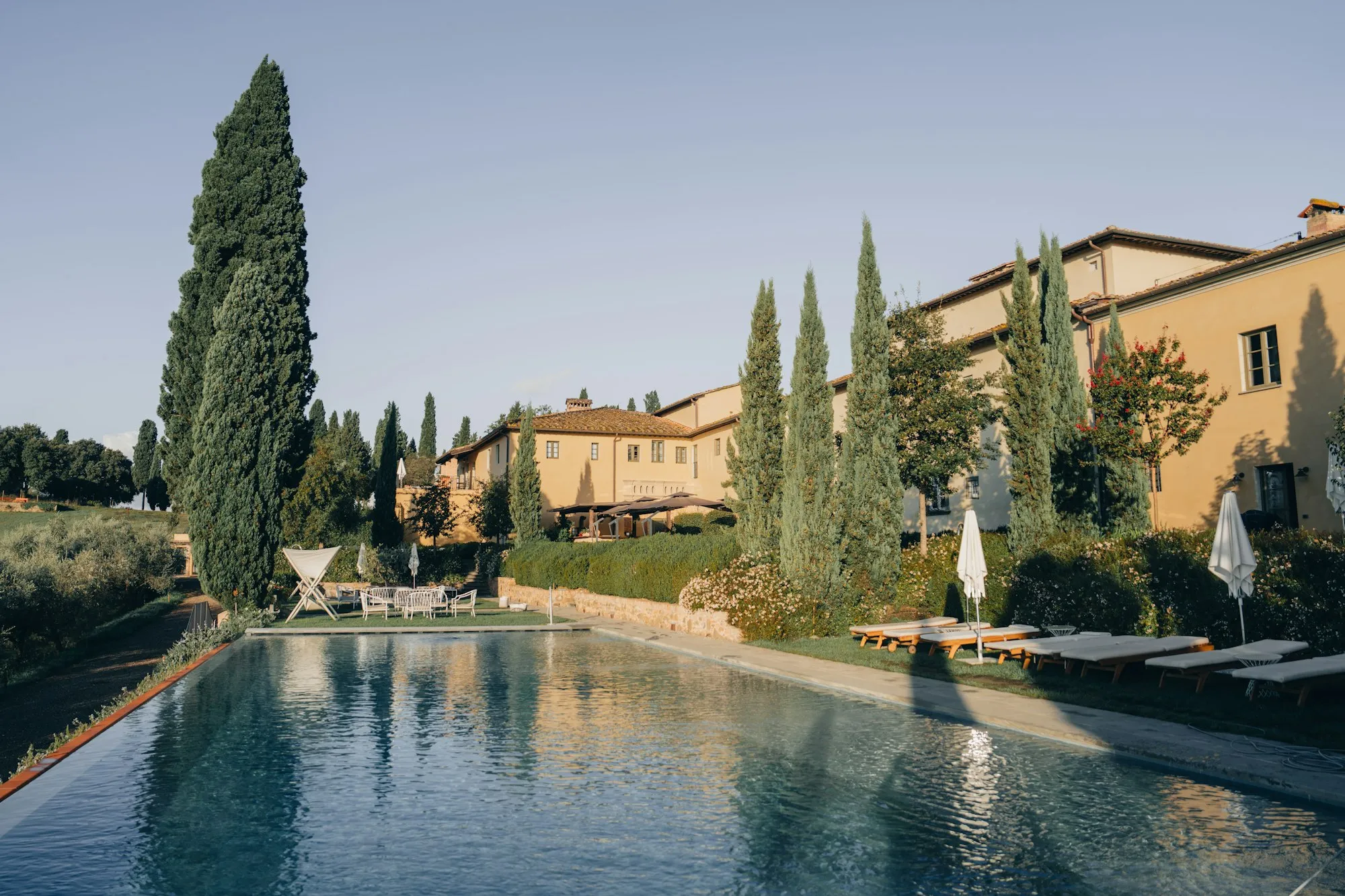 Piscina dell'agriturismo con edifici toscani e cipressi del Chianti, B&B Il Vigneto
